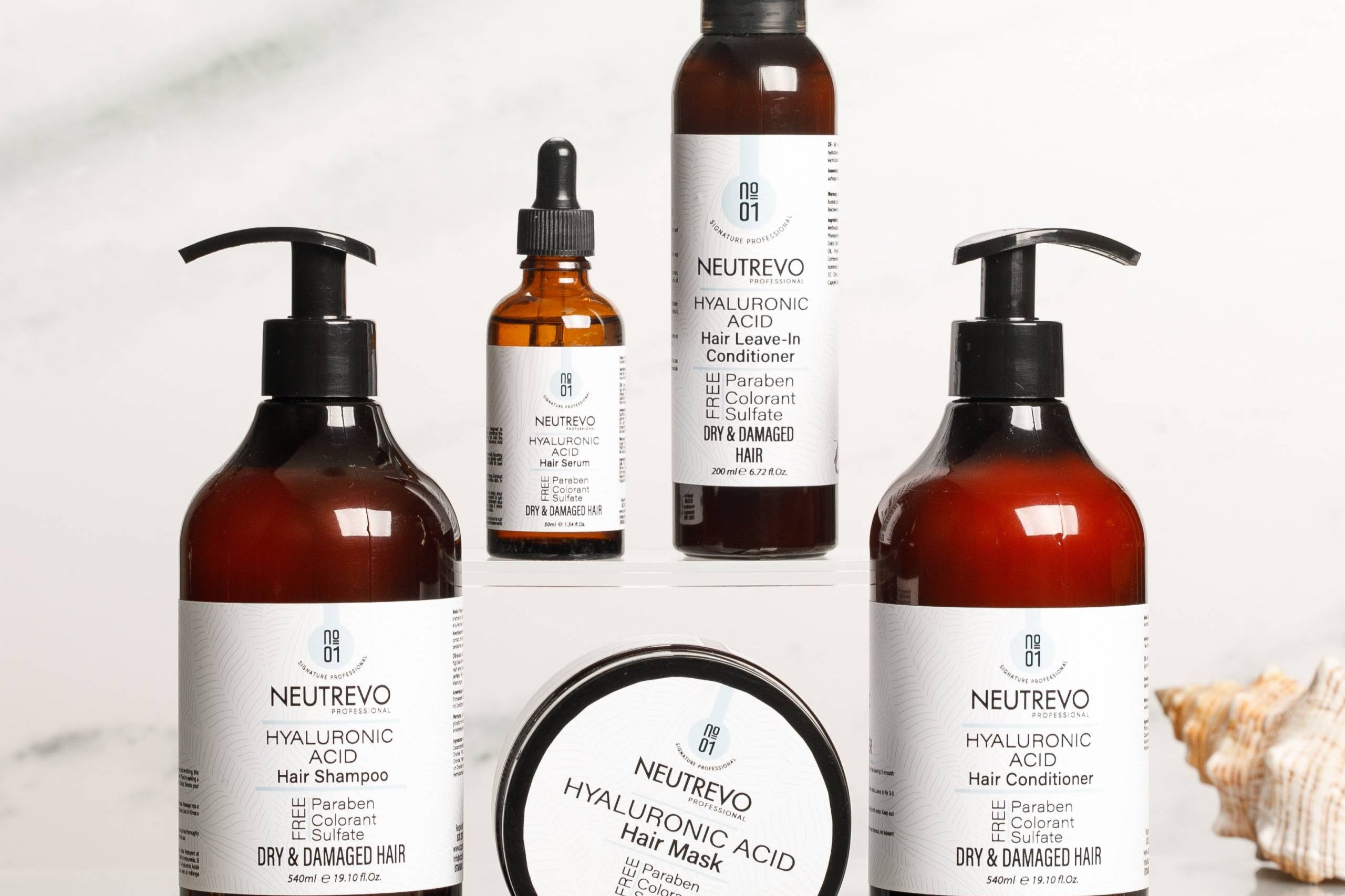 Neutrevo hair care product set including shampoo, conditioner, mask, and leave-in conditioner on a white background.